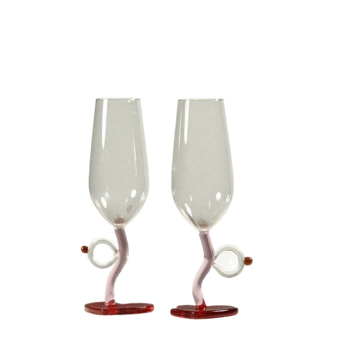 Two clear champagne flutes with twisted pink stems and red circular bases, shown on a plain white background.