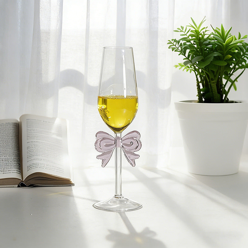 Bowknot stemmed glass with beverage displayed near window light