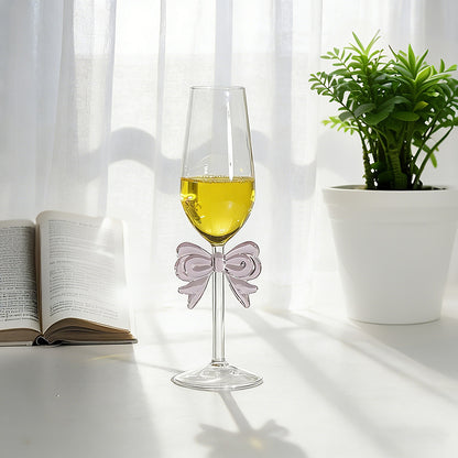 Bowknot stemmed glass with beverage displayed near window light