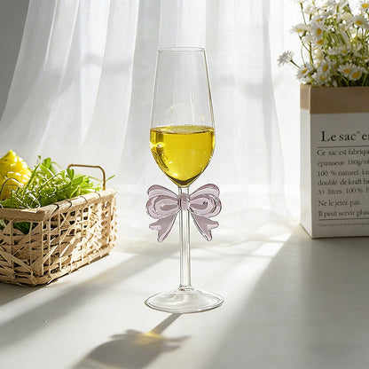 Bowknot stemmed glass with beverage and home decor background