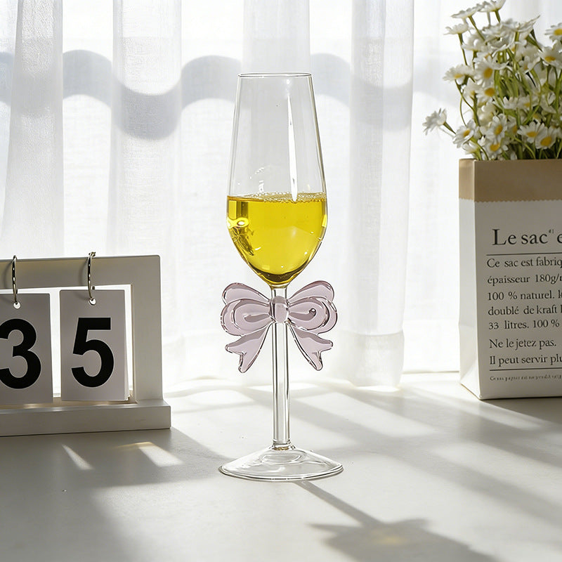 Bowknot stemmed glass placed on table with beverage setting