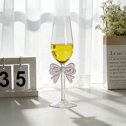 Bowknot stemmed glass placed on table with beverage setting