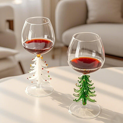 Christmas tree stemmed glasses with beverage displayed on a bright dining table
