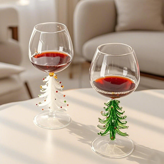Christmas tree stemmed glasses with beverage displayed on a bright dining table