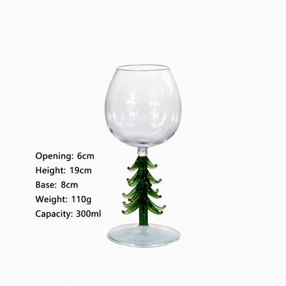 A clear stemmed wine glass with a green Christmas tree-shaped base, shown on a white background with printed dimensions and capacity details on the left.