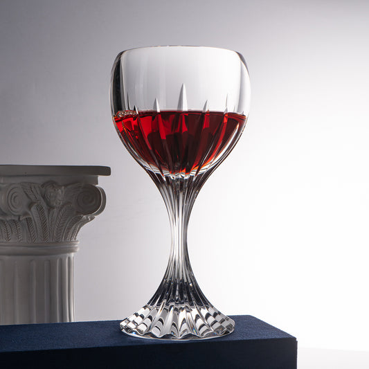 Classic cut stemmed glass filled with beverage displayed on elegant surface