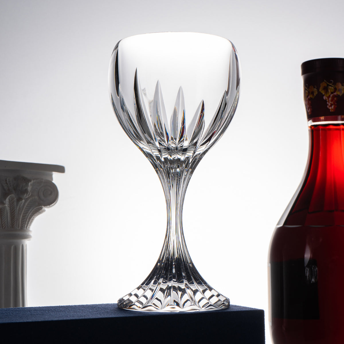Classic cut stemmed glass displayed with bottle on decorative table setting