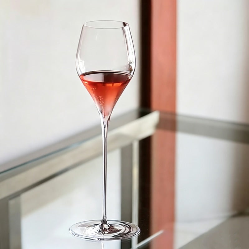 Elegant stemmed glass with beverage placed near window light