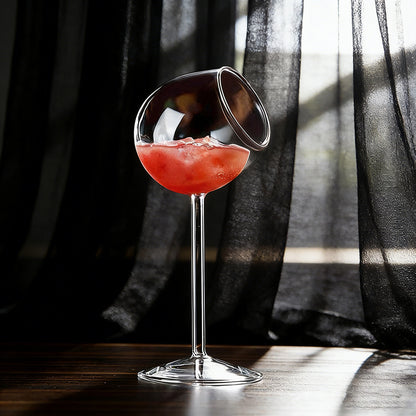 Tilted rim stemmed glass filled with beverage displayed on a dark elegant background