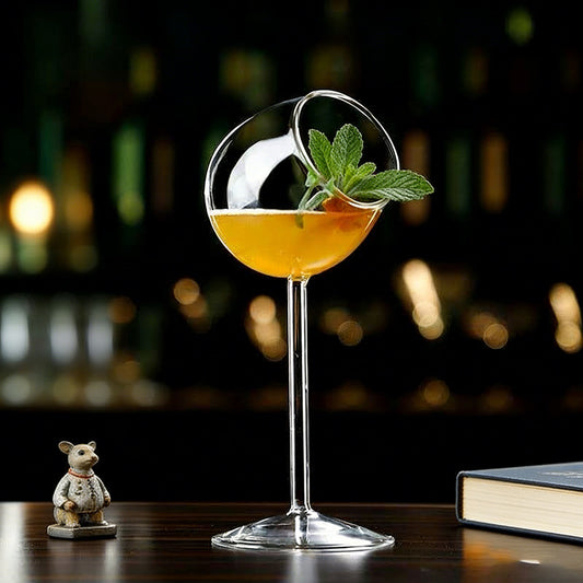 Tilted rim stemmed glass with cocktail drink displayed on a table setting