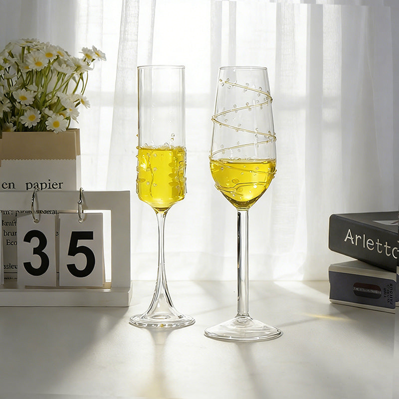 Two styles of decorative stemmed glasses with vine pattern design